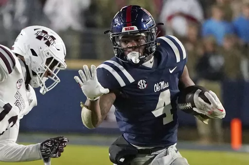 Mississippi running back Quinshon Judkins (4) looks to fend off Mississippi State safety Shawn Preston Jr. (12) during the second half of an NCAA college football game in Oxford, Miss., Thursday, Nov. 24, 2022. Judkins set the Rebels' single-season rushing record and led the SEC with 1,567 yards and 16 touchdowns as a freshman. (AP Photo/Rogelio V. Solis, File)