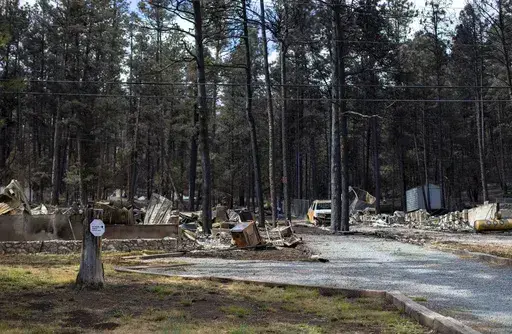 Houses destroyed by the South Fork Fire are pictured in the mountain village of Ruidoso, N.M., Saturday, June 22, 2024. . (AP Photo/Andres Leighton)