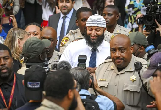 Adnan Syed, center, the man whose legal saga spawned the hit podcast "Serial," exits the Cummings Courthouse after a Baltimore judge overturned his conviction for the 1999 murder of high school student Hae Min Lee on Sept, 19, 2022, in Baltimore. The family of the victim has asked Maryland’s intermediate appellate court to halt Syed’s court case, pending the family’s appeal of a judge’s overturning of Syed’s murder conviction. Prosecutors must decide whether to drop the charges against
