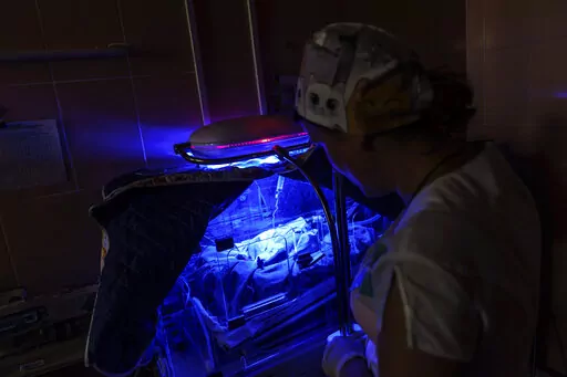 Dr. Tetiana Myroshnychenko, a neonatologist at Pokrovsk Perinatal Hospital, checks on Veronika, a baby born nearly two months prematurely, in Pokrovsk, Donetsk region, eastern Ukraine, Monday, Aug. 15, 2022. In Ukraine’s war-torn eastern Donetsk region, only one hospital under government control remains equipped to care for babies born prematurely in government-held areas. Doctors say the stress caused by the war and rapidly worsening living conditions are leading to more frequent birth compli