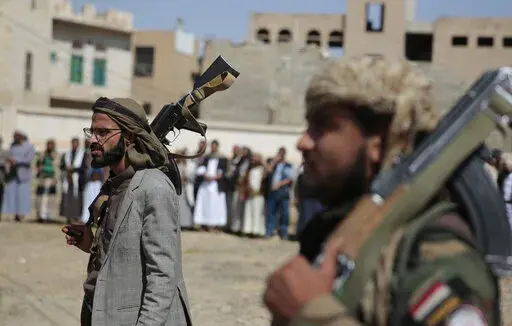 Armed Houthi fighters attend the funeral procession of Houthi rebel fighters who were killed in recent fighting with forces of Yemen's internationally recognized government, in Sanaa, Yemen, on Nov. 24, 2021. Houthi rebels in Yemen are continuing to detain staffers of the former U.S. Embassy in that country. That's according to accounts this week from Yemeni officials, a rights advocate and family members of the detainees. (AP Photo/Hani Mohammed, File)