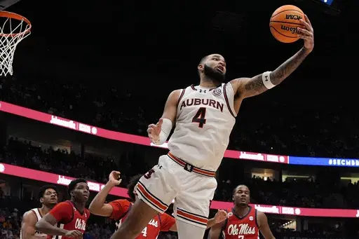 Auburn forward Johni Broome (4) grabs a rebound against the Mississippi during the second half of an NCAA college basketball game in the quarterfinal round of the Southeastern Conference tournament, Friday, March 14, 2025, in Nashville, Tenn. (AP Photo/George Walker IV)