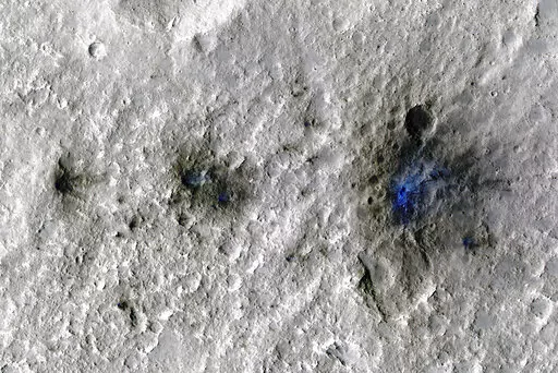 This undated photo released by NASA shows craters that were formed by a Sept. 5, 2021, meteoroid impact on Mars, the first to be detected by NASA’s InSight. Taken by NASA’s Mars Reconnaissance Orbiter, this enhanced-color image highlights the dust and soil disturbed by the impact in blue in order to make details more visible to the human eye. NASA lander on Mars has captured the vibrations and sounds of four meteorites striking the planet's surface. Scientists reported Monday, Sept. 19, 2022