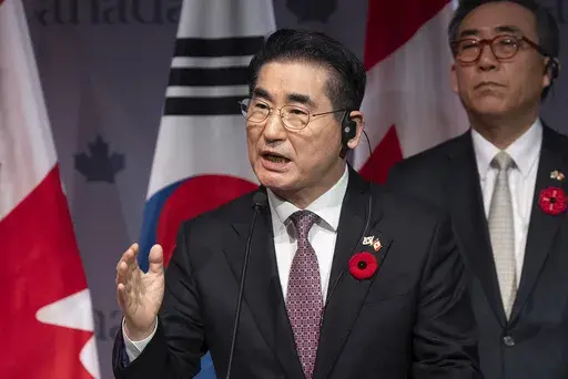 South Korea's Foreign Minister Cho Tae-yul, right, looks on as South Korea's Defense Minister Kim Yong Hyun speaks during a news conference in Ottawa, Ontario, on Nov. 1, 2024. (Adrian Wyld/The Canadian Press via AP, File)