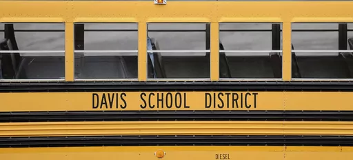 A Davis School District bus sits at the Bus Farm in Farmington, Utah, in this undated photo. A Black woman hired by the northern Utah school district to investigate racial harassment complaints a year after a 10-year-old Black student died by suicide says that she, too, experienced discrimination from district officials. Joscelin Thomas, a former coordinator in the Davis School District's equal opportunity office, alleges in a federal lawsuit that district administrators treated her “as if she