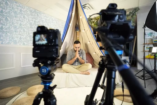 Amin Aaser prays before going live on his nightly "Ramadan Camp" livestream, Thursday, April 13, 2023, in Brooklyn Park, Minn. Aaser has worked nearly every night of Ramadan to present a free online interactive program called Noor Kids Ramadan Camp for Muslim children ages 5-12 from countries around the world. (AP Photo/Abbie Parr)