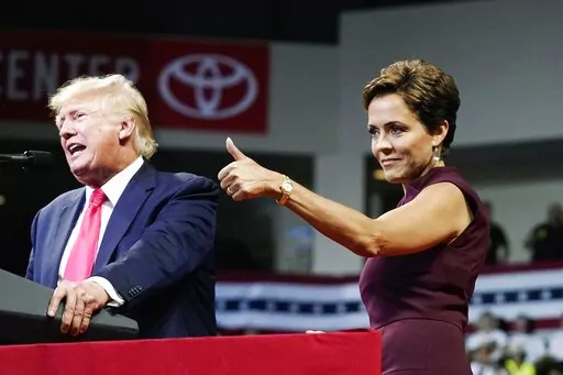 Arizona Republican candidate for governor, Kari Lake, gives a thumbs up to the crowd as former President Donald Trump speaks at a Save America rally on July 22, 2022, in Prescott, Ariz. Lake, a well-known former television anchor, has delighted the segments of the GOP base that have long been at odds with their party’s establishment and want their leaders to confront Democrats, not compromise with them. (AP Photo/Ross D. Franklin, File)