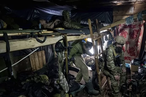 Ukrainian paratroopers of 80 Air Assault brigade rest inside a dugout at the frontline near Bakhmut, Ukraine, Friday, March 10, 2023. (AP Photo/Evgeniy Maloletka)