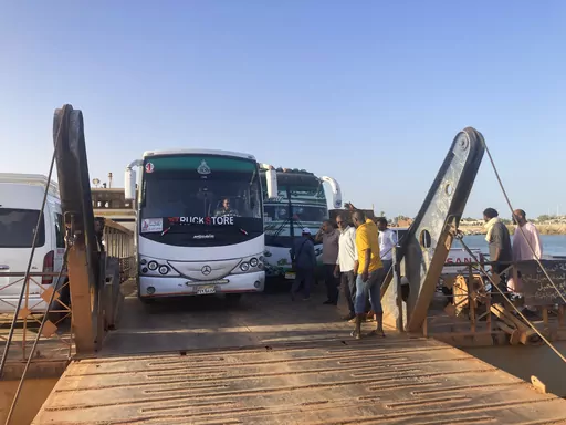 Buses carrying Sudanese, who fled the fighting in Sudan's capital, are leaving a ferry that transported to Egypt's southern city of Abu Simbel on Sunday, May 7, 2023. Tens of thousands of Sudanese crossed into Egypt since the conflict began in mid-April. (AP Photo/ Samy Magdy)