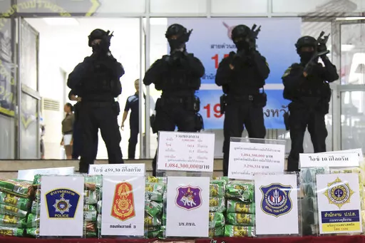 Thai policemen stand in front of packages of methamphetamines on display during a press conference at Narcotics Suppression Bureau in Bangkok, Thailand on July 15, 2019. Police said they seized 459 kilograms (1,012 pounds) of crystal methamphetamine that they suspect originated from neighboring Myanmar. The number of methamphetamine tablets seized in East and Southeast Asia exceeded a billion last year for the first time, highlighting the scale of illegal drug production and trafficking in the r