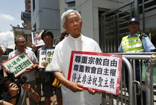 Hong Kong's outspoken cardinal Joseph Zen, center, and other religious protesters hold placards with "Respects religious freedom" written on them during a demonstration outside the China Liaison Office in Hong Kong, Wednesday, July 11, 2012. Reports say a Roman Catholic cardinal and three others have been arrested in Hong Kong on suspicion of colluding with foreign forces to endanger Chinese national security. U.K.-based human rights group Hong Kong Watch said Cardinal Joseph Zen, lawyer Margare