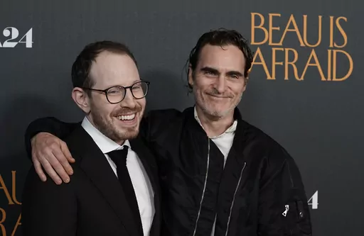 Ari Aster, left, writer/director of "Beau Is Afraid," and star Joaquin Phoenix pose together at the premiere of the film, Monday, April 10, 2023, at the Directors Guild of America in Los Angeles. (AP Photo/Chris Pizzello)
