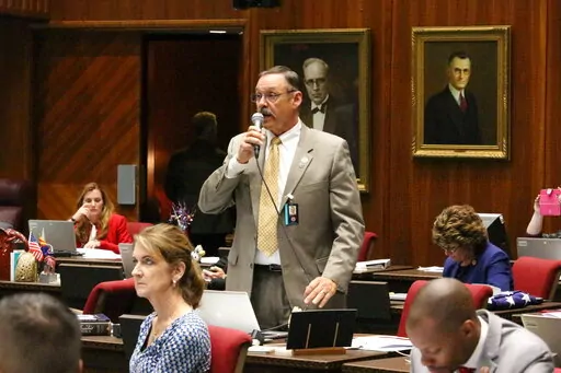 FILE - Republican Rep. Mark Finchem speaks May 2, 2018, at the Capitol in Phoenix. In the year since the Jan. 6 riot, Donald Trump-aligned Republicans have worked to clear the path for next time. In battleground states and beyond, Republicans are systematically taking hold of the once overlooked machinery of elections, weakening or replacing the checks in place to prevent partisan meddling with results. (AP Photo/Bob Christie, File)