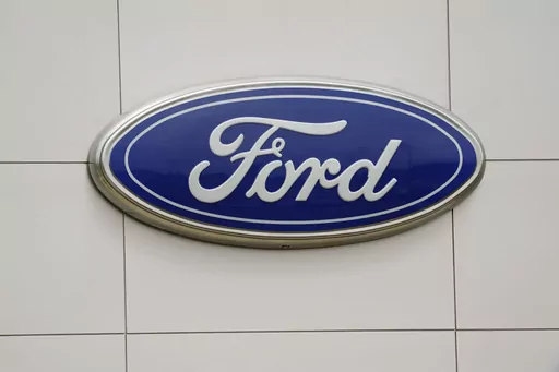 The Ford logo is seen on signage at a Ford dealership, Tuesday, July 27, 2021. The National Highway Traffic Safety Administration is investigating a Ford Motor Co. recall of more than a quarter-million Explorer SUVs in the U.S. after receiving complaints about repairs intended to prevent the vehicles from unexpectedly rolling away even while placed in “park” gear. (AP Photo/Gerry Broome, File)