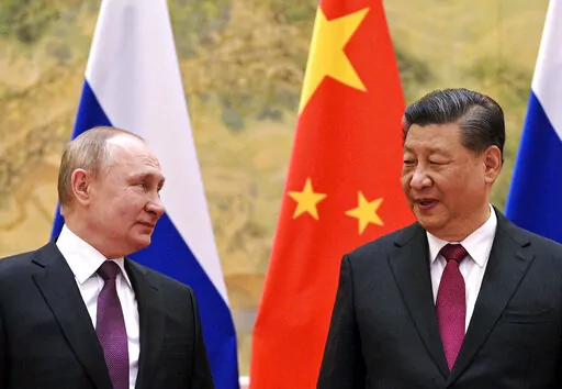 Chinese President Xi Jinping, right, and Russian President Vladimir Putin talk to each other during their meeting in Beijing, China on Feb. 4, 2022. Just weeks before the Feb. 24, 2022, invasion, Xi hosted Putin in Beijing for the opening of the Winter Olympics, at which time the sides issued a joint statement pledging their commitment to a "no limits" friendship. China has since ignored Western criticism and reaffirmed that pledge, underscoring how the two countries have aligned their foreign p