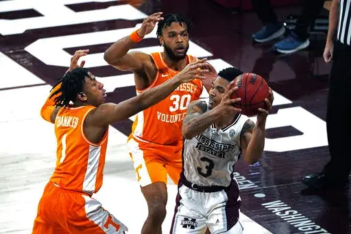 Mississippi State guard Shakeel Moore (3) attempts to pass the ball while Tennessee guards Kennedy Chandler (1) and Josiah-Jordan James (30) defend during the second half of an NCAA college basketball game in Starkville, Miss., Wednesday, Feb. 9, 2022. (AP Photo/Rogelio V. Solis)