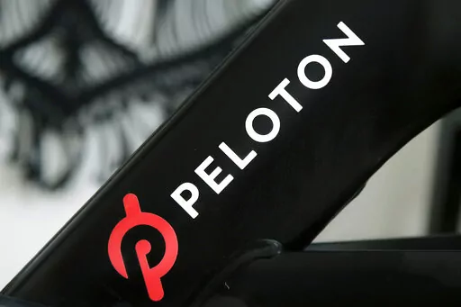 A Peloton logo is seen on the company's stationary bicycle on Nov. 19, 2019, in San Francisco. In a statement  on Wednesday, Aug. 24, 2022, Peloton announced that their high-end exercise bikes and other gear will now be available for purchase on Amazon in the U.S., a partnership aimed at boosting the fitness company's sales that have languished since the easing of pandemic lockdowns. (AP Photo/Jeff Chiu, File)