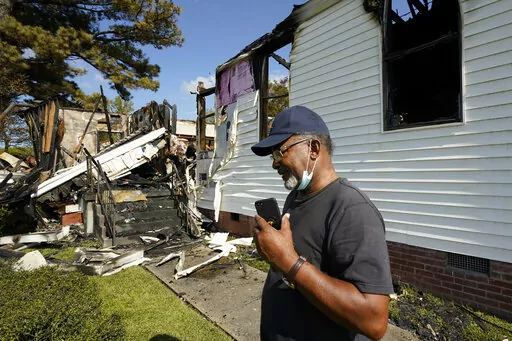 Elder Lloyd Caston, 73, walks around the remains Epiphany Lutheran Church near mid-town Jackson, Miss., Tuesday, Nov. 8, 2022. Authorities in Mississippi's capital city are on the hunt for a suspected arsonist who set several fires early Tuesday morning on and near the campus of Jackson State University, a historically Black public university. At least two of the buildings set ablaze were churches. (AP Photo/Rogelio V. Solis)