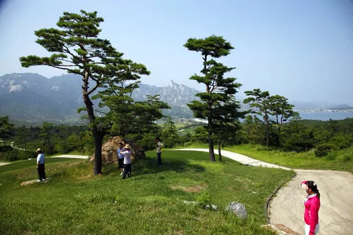 Visitors tour the South Korean-owned golf course at the Mount Kumgang resort, also known as Diamond Mountain, in North Korea on Sept. 1, 2011. North Korea is destroying the golf course in the second confirmed case of South Korean assets being eliminated in an area where the rivals once ran a joint tour program, officials said Tuesday, April 12, 2022, in Seoul. (AP Photo/Ng Han Guan, File)