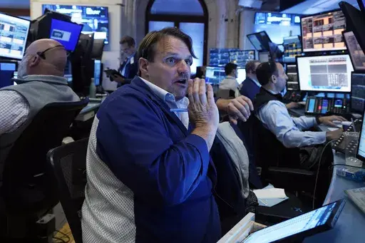 Trader Michael Milano, center, works with colleagues on the floor of the New York Stock Exchange on May 30, 2024. World stocks are mixed on Friday, June 7, 2024, after a steady day on Wall Street as markets anticipate key U.S. jobs data to be revealed later in the day. (AP Photo/Richard Drew, File)