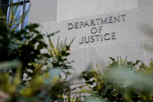 A sign marks an entrance to the Robert F. Kennedy Department of Justice Building in Washington, Jan. 23, 2023. The Justice Department proposed changes Monday, Feb. 5, 2024, to rules governing state-run programs that provide financial assistance to violent crime victims in order to address racial disparities and curb the number of subjective denials of compensation. (AP Photo/Patrick Semansky, File)