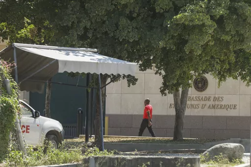 A man enters the U.S. embassy in Port-au-Prince, Haiti, Sunday, March 10, 2024. A charter flight carrying dozens of U.S. citizens fleeing spiraling gang violence in Haiti landed Sunday, March 17, 2024, in Miami, U.S. State Department officials said. (AP Photo/Odelyn Joseph. File)