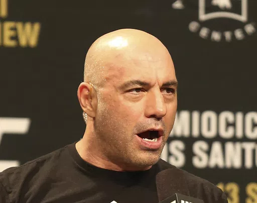 Joe Rogan is seen during a weigh-in before UFC 211 on Friday, May 12, 2017, in Dallas. Spotify has penned a new multi-year partnership deal with Rogan, Friday, Feb. 2, 2024. The enormously popular show will soon also be available on competing platforms, including YouTube and Apple Podcasts. ( AP Photo/Gregory Payan, File)