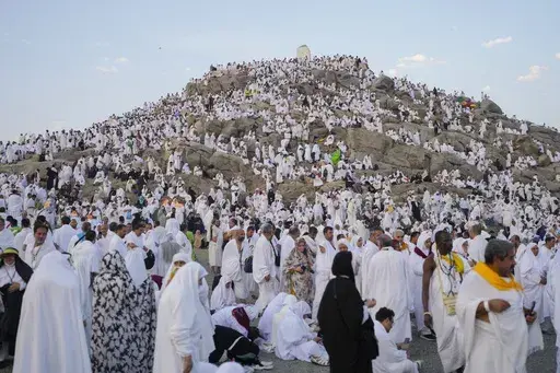 Muslim pilgrims gather at the top of the rocky hill known as the Mountain of Mercy, on the Plain of Arafat, during the annual Hajj pilgrimage, near the holy city of Mecca, Saudi Arabia, Saturday, June 15, 2024. Masses of Muslims gathered at the sacred hill of Mount Arafat in Saudi Arabia for worship and reflection on the second day of the Hajj pilgrimage. The ritual at Mount Arafat, known as the hill of mercy, is considered the peak of the Hajj. It's often the most memorable event for pilgrims, 