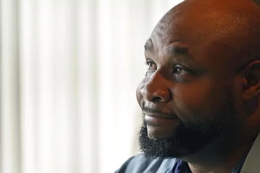 Timothy Norris, a licensed mental health counselor and owner of Mom's Dream Kitchen in Jackson, Miss., speaks during an interview Feb. 14, 2023. Random gunfire, repeated break-ins and an unreliable city water system are constant challenges for the soul food restaurant his mother opened 35 years ago in Mississippi's capital city. (AP Photo/Rogelio V. Solis)