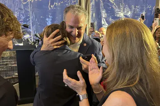 Republican Jimmy Patronis is congratulated during an election night watch party Tuesday, April 1, 2025, in Pensacola, Fla. (AP Photo/Kate Payne)