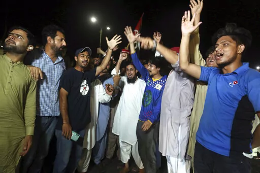 Supporters of an opposition party celebrate the success of a no-confidence vote against Prime Minister Imran Khan, in Karachi, Pakistan, Sunday, April 10, 2022. Pakistan's political opposition toppled Prime Minister Khan in a no-confidence vote in Parliament early Sunday after several political allies and a key party in his ruling coalition deserted him. (AP Photo/Fareed Khan)