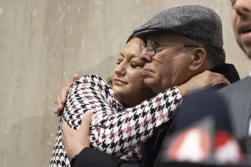Bob Lee's ex wife, Krista Lee, is embraced by Rick Lee, Bob Lee's father, at the Hall of Justice following Nima Momeni's murder trial, Tuesday, Dec. 17, 2024, in San Francisco. (AP Photo/Benjamin Fanjoy)