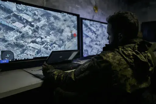 A Ukrainian soldier watches a drone feed from an underground command center in Bakhmut, Donetsk region, Ukraine, Sunday, Dec. 25, 2022. (AP Photo/Libkos, File)