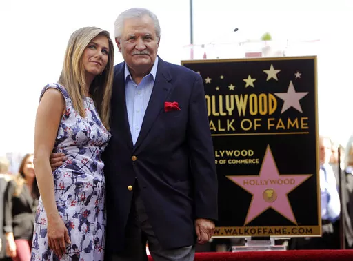 Actress Jennifer Aniston, left, poses with her father, actor John Aniston, after she received a star on the Hollywood Walk of Fame in Los Angeles on Feb. 23, 2012. John Aniston, the Emmy-winning star of the daytime soap opera “Days of Our Lives” and father of Jennifer Aniston, has died at age 89.  The actor’s daughter posted a tribute to him Monday morning on Instagram, announcing that he had died Friday, Nov. 11. (AP Photo/Chris Pizzello, File)