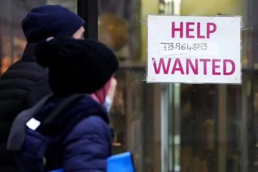 A help wanted sign is displayed outside of a hair salon in Chicago, Thursday, Jan. 5, 2023. If you’re looking for a job or aiming to get a raise this year, a new factor may come into play. It’s called pay transparency, a growing trend for companies to reveal what a job opening or current position pays. (AP Photo/Nam Y. Huh, File)