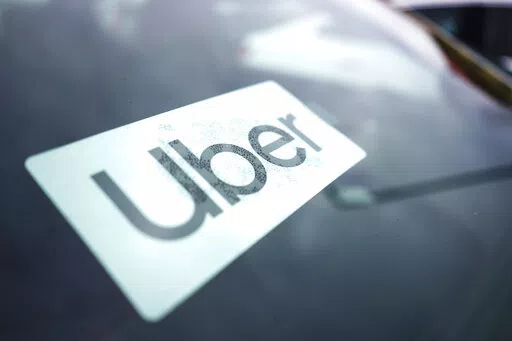 An Uber sign is displayed inside a car in Palatine, Ill., Thursday, Feb. 10, 2022. As Uber pushed into markets around the world, the ride-sharing service lobbied political leaders to relax labor and taxi laws and used a “kill switch″ to thwart regulators and law enforcement. Uber also channeled money through Bermuda and other tax havens and considered portraying violence against its drivers as a way to gain public sympathy. That's according to a report released Sunday by the International Co