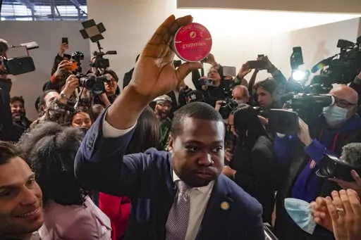 Chris Alexander, center, executive director of New York State Office of Cannabis Management, shows off the first purchase of cannabis gummies bought at Housing Works—New York's first legal cannabis dispensary, during a press conference to kick-off its opening, Thursday Dec. 29, 2022, in New York. Housing Works, a minority-controlled nonprofit serving people with HIV and AIDS, as well as homeless and formerly incarcerated people, will be the first of 36 recently licensed dispensaries to begin s
