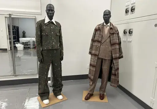 Designs by Jacques Agbobly, left, and Jeffrey Banks, intended for the upcoming Costume Institute exhibit, “Superfine: Tailoring Black Style," appear in the installation room at the Metropolitan Museum of Art in New York on March 20, 2025. (AP Photo/Jocelyn Noveck)