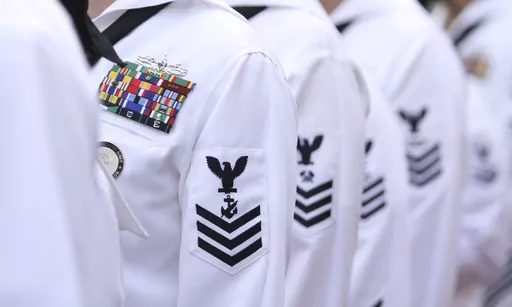 Enlisted sailors line up and wait to march on the field at Sun Life Stadium before the NFL football game in Miami, Nov. 13, 2011, between the Washington Redskins and Miami Dolphins. The Navy will begin randomly testing its special operations forces for steroids and other performance-enhancing drugs beginning in November, taking a groundbreaking step that military leaders have long resisted. Rear Adm. Keith Davids, commander of Naval Special Warfare Command, announced the new program Friday, Sept
