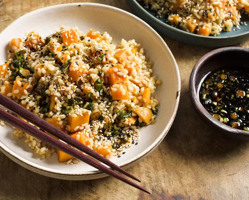 This image released by Milk Street shows a recipe for sweet potato brown rice with soy and scallions. (Milk Street via AP)