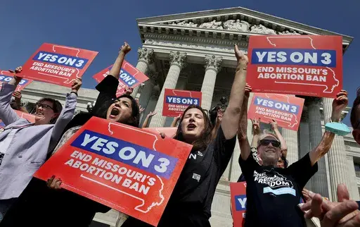 Amendment 3 supporters Luz Maria Henriquez, second from left, executive director of the ACLU Missouri, celebrates with Mallory Schwarz, center, of Abortion Action Missouri, after the Missouri Supreme Court in Jefferson City, Mo., ruled that the amendment to protect abortion rights would stay on the November ballot. Abortion-rights advocates will ask a judge Wednesday, Dec. 4, 2024 to overturn Missouri’s near-total ban on the procedure, less than a month after voters backed an abortion-rights c
