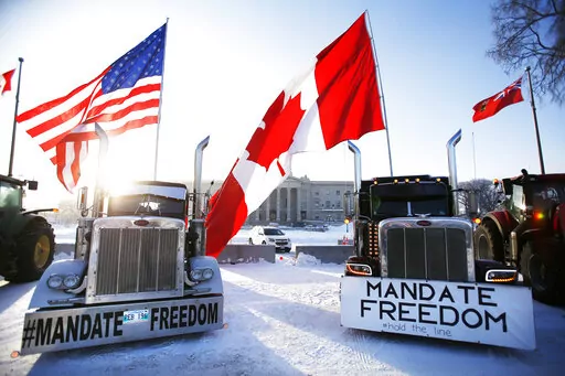 Demonstrators rally against provincial and federal COVID-19 vaccine mandates and in support of Ottawa protestors, Friday, Feb. 4, 2022, outside the Manitoba Legislature in Winnipeg, Manitoba. (John Woods/The Canadian Press via AP)