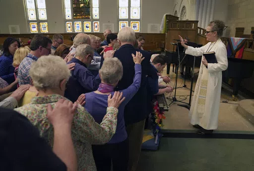 The Rev. Tracy Cox of First United Methodist Church and members of her congregation pray for Tracy Merrick, who will attend the United Methodist General Conference as a delegate representing Western Pennsylvania, as well as Anais Hussian and Joshua Popson who will also be in attendance, Sunday, April 14, 2024, in Pittsburgh. Hussian is a reserve delegate and Popson will be advocating for LGBTQ inclusion with the Love Your Neighbor Coalition. Many, including Rev. Cox, hope that this is the year t