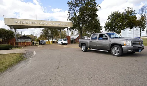 Traffic leaves the front gate to the Mississippi State Penitentiary in Parchman, Miss., Nov. 17, 2021. In January 2023, lawsuits that challenged shoddy living conditions at the prison were dismissed after attorneys said improvements have been made there since 2020. The changes include installation of air conditioning in most of the prison and updates to the electrical, water and sewer systems. (AP Photo/Rogelio V. Solis, File)