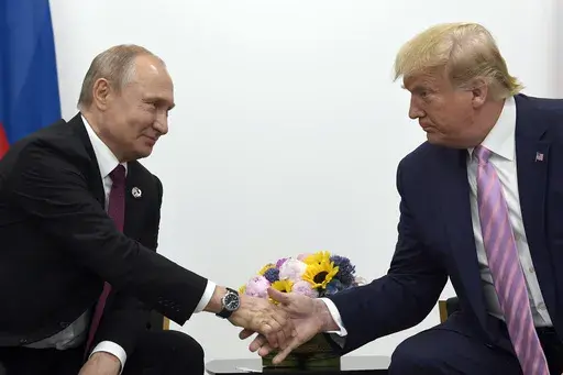 President Donald Trump, right, shakes hands with Russian President Vladimir Putin, left, during a bilateral meeting on the sidelines of the G-20 summit in Osaka, Japan, June 28, 2019. (AP Photo/Susan Walsh, File)