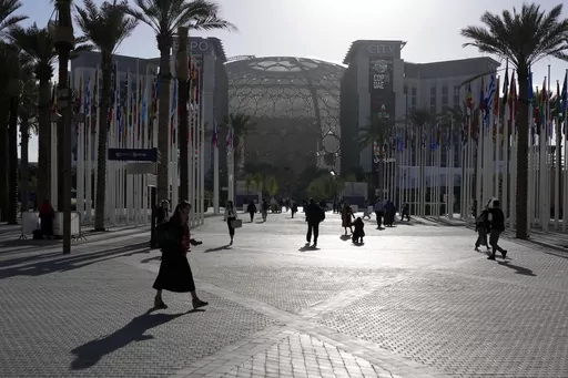 People walk through the venue at the COP28 U.N. Climate Summit near the Al Wasl Dome at Expo City, Thursday, Nov. 30, 2023, in Dubai, United Arab Emirates. (AP Photo/Rafiq Maqbool, File)
