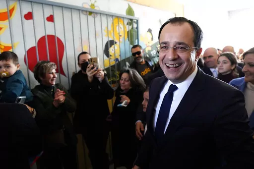 Presidential candidate Nikos Christodoulides smiles as walks with his supporters after casting his vote during the presidential elections in Geroskipou in south west coastal city of Paphos, Cyprus, Sunday, Feb. 12, 2023. Voting has started in a runoff to elect ethnically split Cyprus' eighth new president, pitting a former foreign minister who campaigned as a unifier eschewing ideological and party divisions against a popular veteran diplomat. Some 561,000 citizens are eligible to vote and both 
