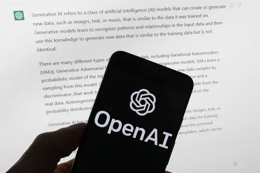 The OpenAI logo is seen on a mobile phone in front of a computer screen displaying output from ChatGPT, on March 21, 2023, in Boston. European lawmakers have rushed to add language on general artificial intelligence systems like ChatGPT as they put the finishing touches on the Western world's first AI rules. (AP Photo/Michael Dwyer, File)