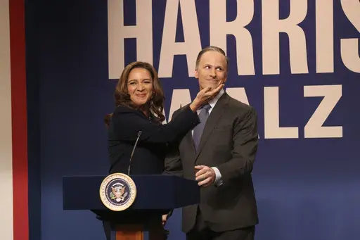 This image released by NBC shows Maya Rudolph as Kamala Harris, left, and Andy Samberg as Douglas Emhoff, during the cold open sketch on "Saturday Night Live" in New York on Saturday, Sept. 28, 2024. (Will Heath/NBC via AP)