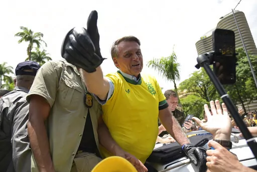 Brazil's President Jair Bolsonaro flashes a thumbs up as he greets supporters during a campaign rally in Praca da Liberdade or Liberty Square, in Belo Horizonte, Brazil, Saturday, Oct. 29, 2022. Bolsonaro is facing former President Luiz Inacio Lula da Silva in a runoff election set for Oct. 30. (AP Photo/Yuri Laurindo)